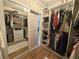 Walk-in closet offers ample storage space, featuring built-in shelving, hanging rods, and a mirrored wall at 152 Weatherstone Pkwy, Marietta, GA 30068