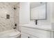 Bathroom features a white vanity with a black faucet and a modern shower at 2058 Detroit Nw Ave, Atlanta, GA 30314