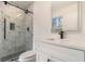 Bathroom features a walk-in shower, white vanity, and a modern frameless mirror at 2058 Detroit Nw Ave, Atlanta, GA 30314