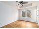 Bedroom boasts wood floors, white walls, a ceiling fan, and lots of natural light at 2058 Detroit Nw Ave, Atlanta, GA 30314