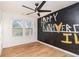 Bedroom features a ceiling fan, wood floors, and chalkboard paint on one wall at 2058 Detroit Nw Ave, Atlanta, GA 30314