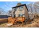 View of the backyard with wood deck of two-story home with gray siding at 2058 Detroit Nw Ave, Atlanta, GA 30314