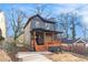 Recently renovated two-story home featuring a covered front porch with natural wood pillars and railings at 2058 Detroit Nw Ave, Atlanta, GA 30314