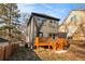 The home features a deck, neutral siding, and black framed windows against a leafy backdrop at 2058 Detroit Nw Ave, Atlanta, GA 30314