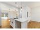 Modern kitchen island with pendant lighting and a view into the living room at 2058 Detroit Nw Ave, Atlanta, GA 30314