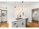 Bright kitchen island featuring a breakfast bar, modern pendant lights, and hardwood floors at 2058 Detroit Nw Ave, Atlanta, GA 30314