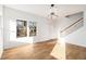 Open-concept living room featuring hardwood floors, recessed lighting, a staircase, and large bright windows at 2058 Detroit Nw Ave, Atlanta, GA 30314