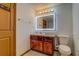 Bathroom with granite vanity, decorative mirror and lighting, and toilet at 2436 Green Hollow Ct, Conyers, GA 30012