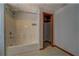 Simple bathroom including a bath tub with a shower, tile surround and a closet at 2436 Green Hollow Ct, Conyers, GA 30012