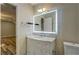 Charming bathroom vanity and accent mirror with wood flooring in the background at 2436 Green Hollow Ct, Conyers, GA 30012