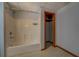 Full bathroom with white tub and shower combo, white tile, and wood trim door at 2436 Green Hollow Ct, Conyers, GA 30012