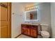 Bathroom with a wood vanity, lighted mirror and tile flooring at 2436 Green Hollow Ct, Conyers, GA 30012