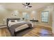 Comfortable bedroom with wood floors, ceiling fan, and natural light at 2436 Green Hollow Ct, Conyers, GA 30012