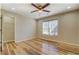 Bedroom featuring hardwood floors, a ceiling fan and a closet space at 2436 Green Hollow Ct, Conyers, GA 30012