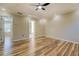 Bright bedroom featuring hardwood floors, modern ceiling fan, and doorway view at 2436 Green Hollow Ct, Conyers, GA 30012