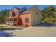Brick home featuring an attached garage, a large driveway, and manicured landscaping at 2436 Green Hollow Ct, Conyers, GA 30012