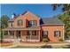 Charming two-story brick home featuring a welcoming front porch and well-manicured landscaping at 2436 Green Hollow Ct, Conyers, GA 30012