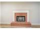 Close-up of a brick fireplace with a white mantle and decorative hearth at 2436 Green Hollow Ct, Conyers, GA 30012