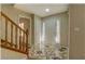 Inviting foyer with neutral walls, patterned flooring, and a wooden staircase at 2436 Green Hollow Ct, Conyers, GA 30012