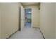 Hallway with neutral paint, tile floors and access to other parts of the house at 2436 Green Hollow Ct, Conyers, GA 30012