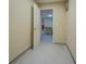 Hallway entrance to kitchen featuring light tile flooring and a white door at 2436 Green Hollow Ct, Conyers, GA 30012