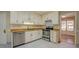 Traditional-style kitchen with stainless steel appliances, light cabinets, and light granite countertops at 2436 Green Hollow Ct, Conyers, GA 30012