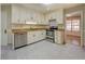 Well-lit kitchen with white cabinets, stainless steel appliances, and tile flooring at 2436 Green Hollow Ct, Conyers, GA 30012