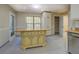 Kitchen island with custom detailing, tile flooring, and view to walk-in pantry at 2436 Green Hollow Ct, Conyers, GA 30012