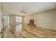 Bright and airy living room featuring a classic fireplace, hardwood floors, and large window at 2436 Green Hollow Ct, Conyers, GA 30012