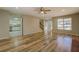 Open-concept living room showcasing wood floors and seamless transition to the foyer and kitchen at 2436 Green Hollow Ct, Conyers, GA 30012