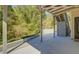Covered patio area features concrete flooring, wood support beams, and stairway closet for added storage at 2436 Green Hollow Ct, Conyers, GA 30012
