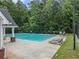 Community swimming pool with lounge chairs and a shaded area for relaxation at 2436 Green Hollow Ct, Conyers, GA 30012