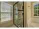 Modern walk-in shower with sleek glass doors and tiled surround at 2436 Green Hollow Ct, Conyers, GA 30012