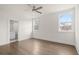 Bright, empty bedroom features two windows, hardwood floors, ceiling fan and ensuite bathroom at 2517 Canopy Ct, Marietta, GA 30066