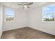 Well-lit bedroom with hardwood flooring, two windows, and neutral wall paint at 2517 Canopy Ct, Marietta, GA 30066