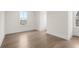 A bedroom featuring light hardwood flooring, white trim, and a window for natural light at 2517 Canopy Ct, Marietta, GA 30066