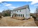 Back exterior view of house showing a wooden deck and a large yard at 2517 Canopy Ct, Marietta, GA 30066