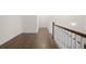 Hallway featuring hardwood floors, white trim, and a view of the staircase at 2517 Canopy Ct, Marietta, GA 30066