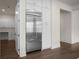 Kitchen featuring stainless steel refrigerator, white cabinets and hardwood floors at 2517 Canopy Ct, Marietta, GA 30066