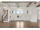 Open-concept living room with beautiful hardwood floors, wooden ceiling beams and bright French doors at 2517 Canopy Ct, Marietta, GA 30066