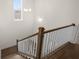 A view from the top of a staircase with hardwood steps and white railings in a modern home at 2517 Canopy Ct, Marietta, GA 30066