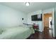 This bedroom features dark wood floors, a mounted TV, and a comfortable bed at 275 Fern Crest Dr, Lawrenceville, GA 30046