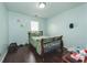 Bedroom with a large bed, minimal decor, and hardwood floors at 275 Fern Crest Dr, Lawrenceville, GA 30046