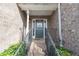 Inviting covered entryway showcasing brick steps with wrought iron railing leading up to the front door at 275 Fern Crest Dr, Lawrenceville, GA 30046