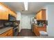 Well-lit kitchen featuring wooden cabinets, stainless steel appliances, and modern countertops at 275 Fern Crest Dr, Lawrenceville, GA 30046