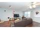 Cozy living room with wood floors, a ceiling fan, and direct access to the backyard at 275 Fern Crest Dr, Lawrenceville, GA 30046