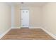 A finished basement room featuring wood floors, a crisp white door, and neutral wall paint at 3716 Loren Dr, Decatur, GA 30032