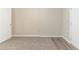 A minimal bedroom featuring neutral carpet, neutral wall paint, and white trim at 3716 Loren Dr, Decatur, GA 30032