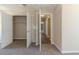 Bedroom with neutral carpet, closet, and doorway leading to hallway with hardwood flooring at 3716 Loren Dr, Decatur, GA 30032