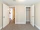 A carpeted bedroom featuring closet and hallway access at 3716 Loren Dr, Decatur, GA 30032